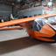 Orange and Black glider fuselage with wing centre section in hangar