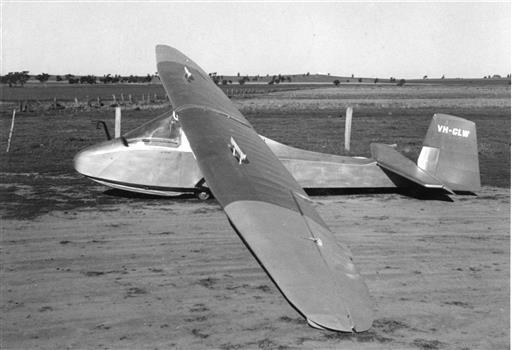 Side view of glider at rest in field