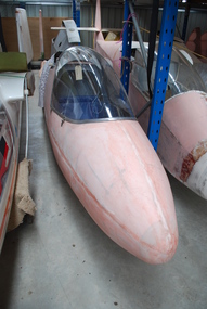 Glider fuselage in hangar storage