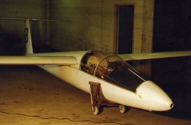 White sailplane in basement workshop