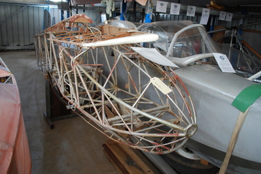 Bare steel tube fuselage frame in storage 