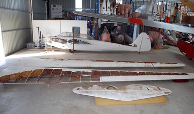 Derigged glider components on hangar floor