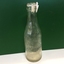 Old Charlton coridal bottle being show or a green background.