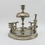 Silver stand to hold 8 pipes and pipe cleaner, A bell on top. Match striker plate and cigar cutter. Candle holder on top. Tarnished.
