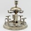 Silver stand to hold 8 pipes and pipe cleaner, A bell on top. Closer view of cigar cutter. Candle holder on top. Tarnished.