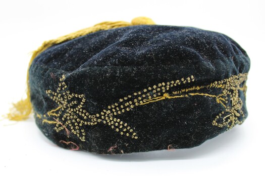 Closer view of the yellow beading on the side of the cap. Flower and leaf motif.