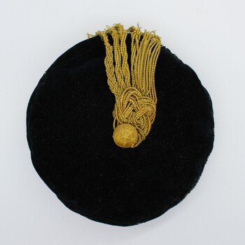 Top view of smokers cap showing tassel knot on top. 