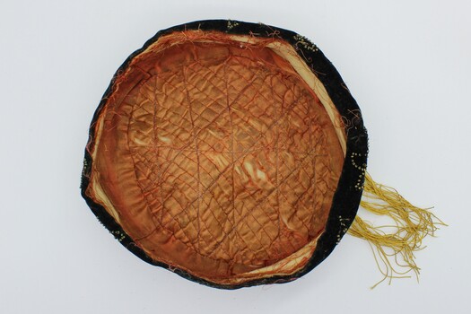 Inside lining of the smokers cap. Showing the stitching and gold coloured lining.