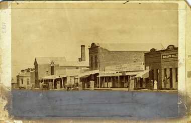 Looking down High Street, Charlton, The shops include the Bank of Victoria, Malcolm's Flour Mill, Procteas Butchers shop, Golden Fleece Hotel, Johnson's Bridge store, dinning room and bank of NSW,