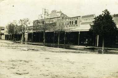 1911 Flooded High Street, showing street store front, Wylies general store in the middle withe Goldern Fleece Hotel.