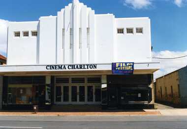 Art deco movie theatre front, taken from the street. All white painted front with sign reading "Cinema Charlton" and banner reading "Film Festival 25-26 Feb".