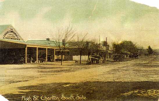 Looking down High Street at the shops and buildings. Charlton Foundry sign on the first shop with horses and carriages out front.