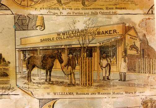 Copy of 1891 Lithograph. Sepia tones. W. Williams Saddle Collar & Harness Maker. Three men in front of shop; one holding a horse, two in aprons. Text at bottom of picture reads "W. Williams, Saddle & Harness Maker, High Street"