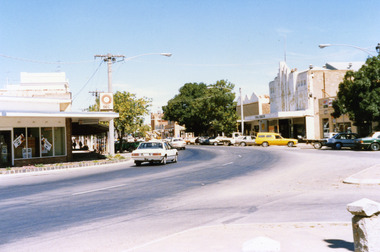 High St Charlton showing west end shops. SEC office on LH side, on the RH side is Paterson's Fibre Glass Factory, Charlton Cinema. Yellow panel van parked in front of cinema.