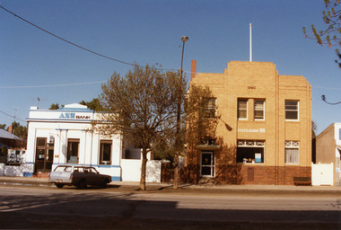 ANZ Bank and State Bank buildings in High St Charlton. The ANZ building is single storey, painted blue and white. The State Bank a two storey brick building with red bricks and cream bricks above.
