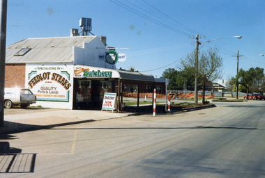 Turner's Butcher Shop on the corner of Learmonth and High Streets. Sign above the verandah reads Turners Butchery and has a picture of a ram's head between the two words. 