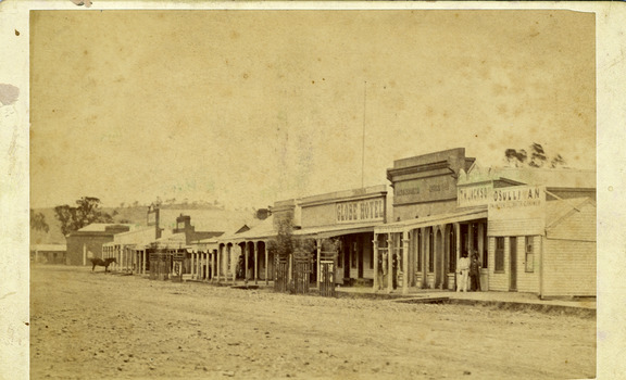  Buildings left to right: residence, Mechanics Institute, general store, shop, Stowe's fruit & veg shop, Globe Hotel. Wide dirt main street.