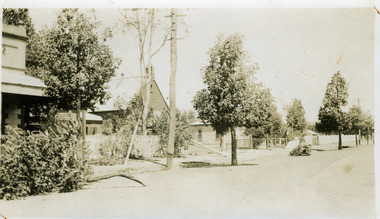 Brick church building with an iron roof. It has a bell tower and the lettering A . D 1871 on the front of the building. A picket fence runs along the front.