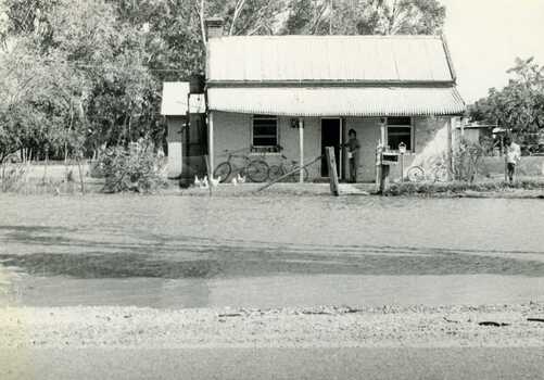 Feb 1973 flood. Old Ive's house with floodwater to front fence on Calder Highway opposite Charlton Park Gates.