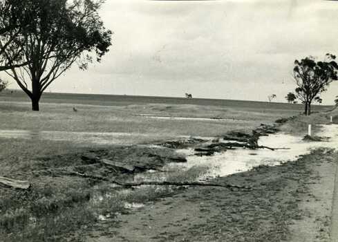 Flood water and damage to Mc Gurk's fence an Calder Highway in 1971 flood.