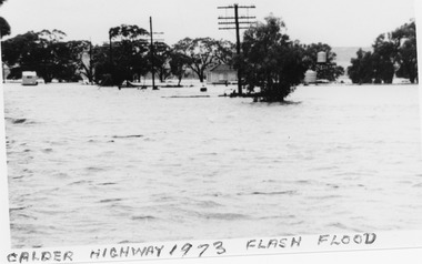 Flood waters spreadout over a wide area. A caravan and brick house stand isolated to the water.