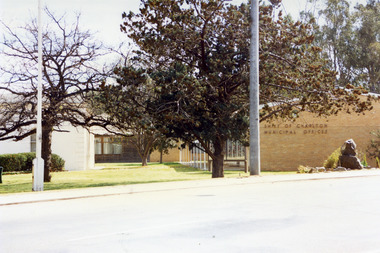 Cream brick Municipal Offices with Senior Citizens Clubroom in background. The garden and park area are in front.