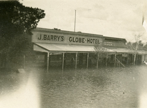 Flood waters lap at the door of the Globe Hotel.