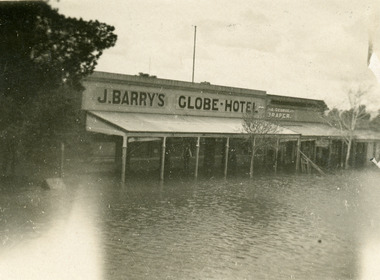 Flood waters lap at the door of the Globe Hotel.