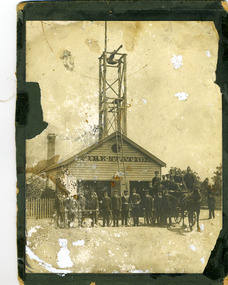 Wooden fire station c.1911. In front are the brigade members with a horse drawn fire cart.