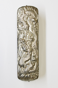 Top view of brush showing silver embossing. The embossing is of a Dragon.