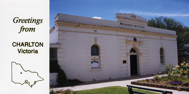White brick building, Mechanics Institute 1882 on the building. Rose garden and lawn in front
