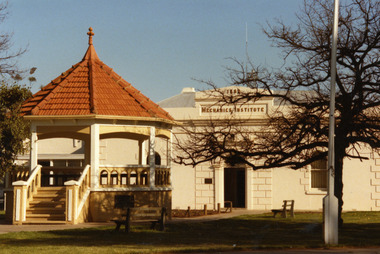 Red tiled brick rotunda in the middle of garden.