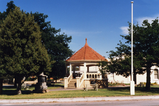 Red tiled brick rotunda in the middle of garden.