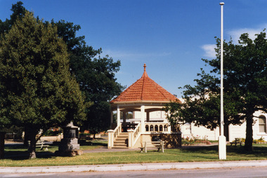 Red tiled brick rotunda in the middle of garden.