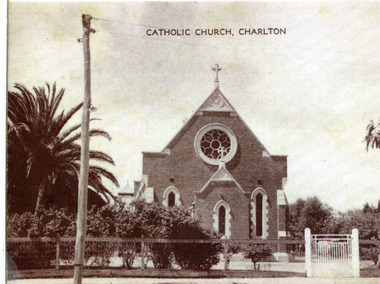 Front of brick church showing the circular stained glass window.