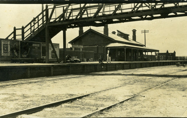 Charlton railway station and overhead bridge. Railway tracks are in the foreground.