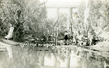 Looking along the Avoca River to the railway bridge overhead. Two girls standing on the banks of the river.