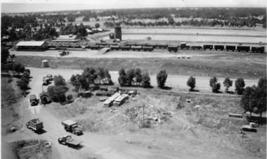 Aerial view of Charlton railway station and dam. A number of carriages are lined up on the tracks.