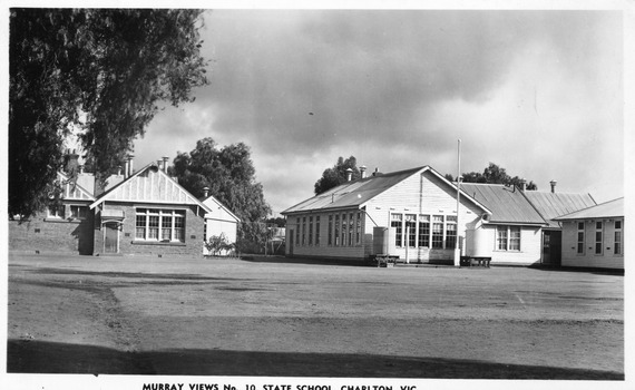 Three school buildings, one brick the other are weatherboard. In front is the school oval.