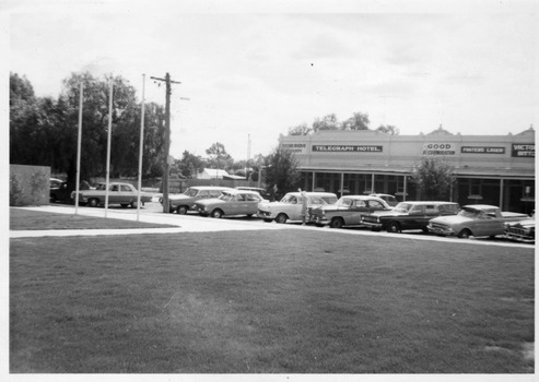 View of Telegraph hotel with row of cars in front.
