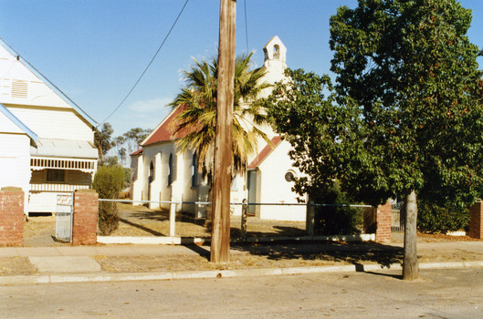 Street view of white brick church. St Andrew's Presbyterian Church