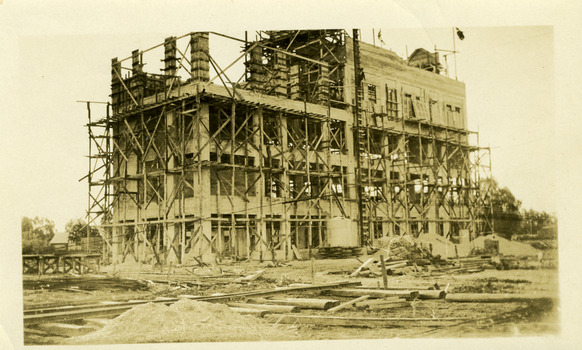 Sepia photo showing construction of four storey flour mill, Still a building site with mill two thirds complete.