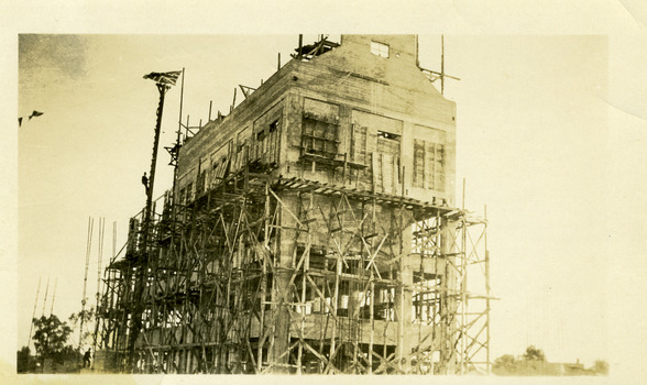 Sepia photo showing construction of four storey flour mill, Still a building site with mill two thirds complete.