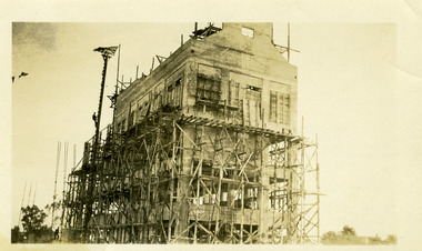 Sepia photo showing construction of four storey flour mill, Still a building site with mill two thirds complete.