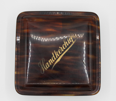 Glossy brown and tan translucent square box with lid. 