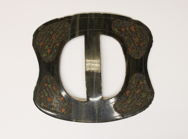 Handmade Belt buckle,  oval shaped with patterned engraving on each corner around a circular opening. 
