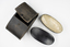 Leather case & 2 wooden backed hair brushes, bristles set in metal