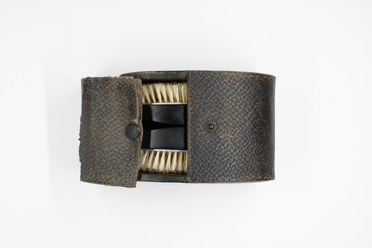 Leather case & 2 wooden hair brushes packed in case.