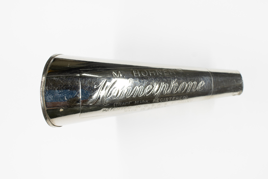 A hohner harmonica featuring a horn outlet.