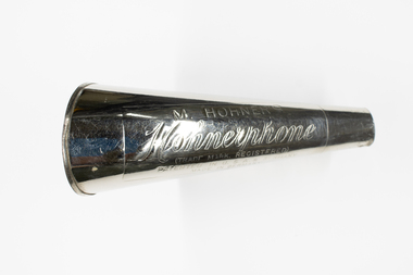 A hohner harmonica featuring a horn outlet.